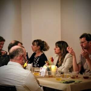 Photo of people eating together at Paired Provisions, an event which brings together some of the region's finest specialty food and beverage producers for a guided tasting experience, surrounded by contemporary art in the Jane Altes Gallery, in Troy, NY.